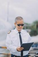 Professional pilot woman in uniform has teamwork meeting for success flight in aviation business. Young female captain instructor sitting in office and working or training commercial airline crew. photo