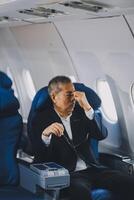 headache in the airplane, man passenger afraid and feeling bad during the flight in plane photo