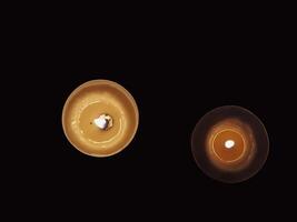 Scented candles in the dark at night for a spa or relaxation background. photo