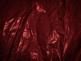 Wrinkled paper texture in dark red tones for a mysterious background. photo