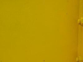 Yellow painted steel texture for a close-up background of a building or construction. photo