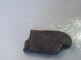 Rocks and reflections on a white background for a minimalist product background. photo
