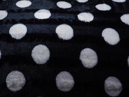 White polka dot carpet texture on black for background. photo