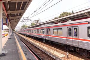 Jakarta, Indonesia, 2024 - View of a commuter line train platform in Jakarta. The commuter line train stop at the Lenteng Agung station. Mass public transportation in Jakarta. photo