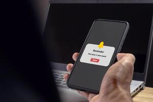Man holding a mobile phone with reminder notifications page on screen. New event notice message on mobile phone. photo
