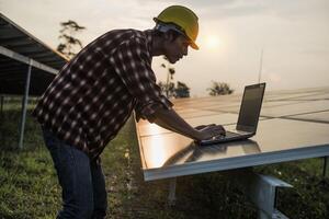 Male engineer working at high level to check efficiency of solar cell from clean solar cell which is friendly to environment. photo