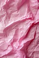 Crumpled pink paper texture, close up view. Abstract vertical background. photo