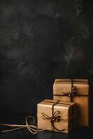 Wrapped gifts tied with twine rest on dark textured background. Holiday celebration. photo