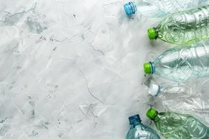 Discarded plastic bottles on light gray textured surface with copy space photo