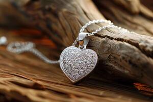 Silver heart pendant with sparkling stones on wooden surface. Valentine's Day gifts. photo