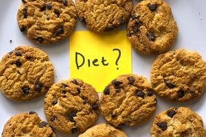 Chocolate chip cookies on withe background with a Diet text written on a sticky note photo