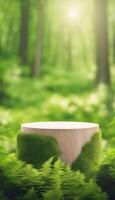 Raised cylindrical wooden base surrounded by green plants for displaying natural products, with ferns. Blurred forest background. Portrait view suitable for mobile phone photo