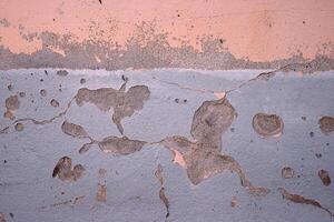 Weathered wall with peeling paint in pastel pink and gray. Ideal for backgrounds, urban photography, grunge textures, vintage aesthetics, creative design elements. Copy space photo