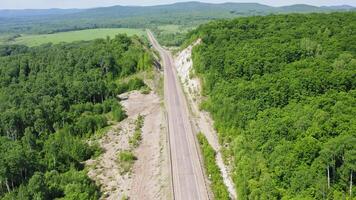 Drone view of a country road in a forest without cars video