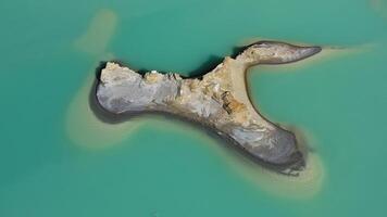 Drone view of the turquoise lake formed as a result of mining waste video