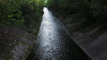 Drone view of an artificial canal in a green forest video