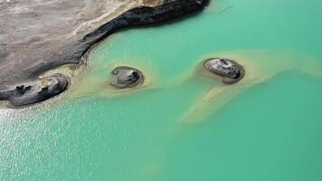 Drone view of the turquoise lake formed as a result of mining waste video