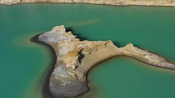 Drone view of the turquoise lake formed as a result of mining waste video