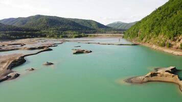 Drone view of the turquoise lake formed as a result of mining waste video