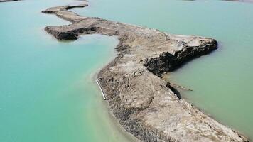Drone view of the turquoise lake formed as a result of mining waste video