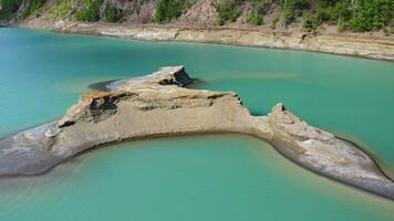Drone view of the turquoise lake formed as a result of mining waste video