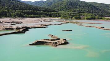 Drone view of the turquoise lake formed as a result of mining waste video