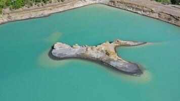 Drone view of the turquoise lake formed as a result of mining waste video