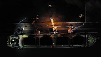View from a drone vertically down to cargo cranes working in the port at night video