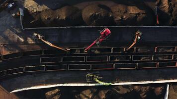 Excavators unloading coal from a cargo train. video
