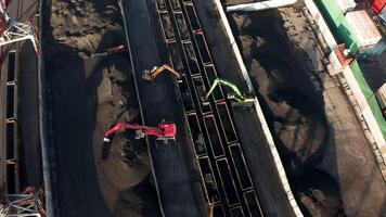 Excavators unloading coal from a cargo train. video
