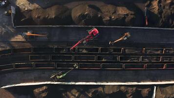Aerial view top down on excavators unloading coal from a cargo train video