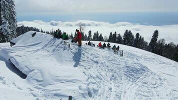 A group of ski touring enthusiasts on top of a snow-covered mountain video