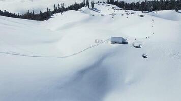A group of ski touring enthusiasts climbs to the top of a snow-covered mountain video