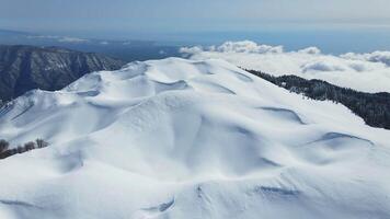 Snow-capped peak of Mount Mamdzyshkha on a sunny day in winter video