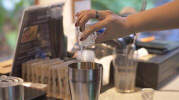 Close up of a hand putting a drink topping into a glass video