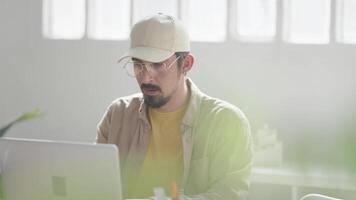Man working remotely from home on computer desk video