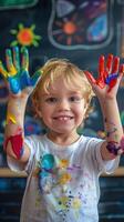 Young Smiling Child with Colorful Painted Hands in Art Studio photo