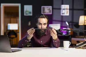 Influencer in home studio films tablet review for tech enthusiasts. Viral media star hosts technology internet show, unboxing digital portable device, feeling impressed by thinness photo