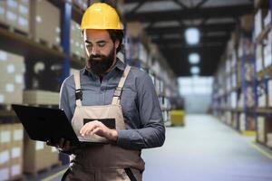 Storage room worker verifying list of parcels on depot racks, counting all merchandise prepared for shipment and transportation. Packaging engineer managing distribution logistics and management. photo