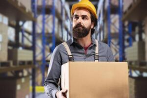 Facility manager carrying boxes with merchandise around depot, working on managing important delivery or transportation. Engineer doing products quality control and inventory based on labels. photo