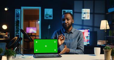 Tech internet star filming chroma key gaming laptop unboxing, giving reasons to purchase it. Influencer capturing urging viewers to buy sponsoring partner mockup notebook photo