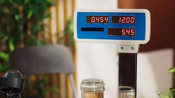 Close up of electronic scale in zero waste supermarket with low carbon dioxide emissions. Panning shot of weighing machine in local grocery store used for bulk products, fruits and vegetables photo