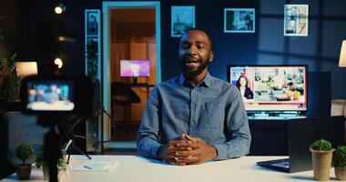 Happy influencer arrives in home studio, using professional camera to film live broadcast for online streaming platforms. Viral online star hosts q a session with audience using recording gadgets photo