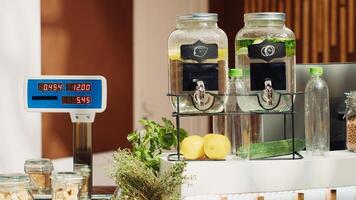 Close up of electronic scale in eco friendly zero waste supermarket next to freshly harvested produce. Panning shot of weighing machine in green living local shop used for bulk products photo