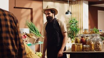 Vendor greeting first clients in newly opened plastic free zero waste supermarket, removing red ribbon. Trader welcoming shoppers inside sustainable eco friendly local neighborhood store photo