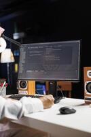Detailed shot of computer screen displaying sleek software app interface, highlighting app development and user interface design. Image shows man engrossed in writing and examining code. photo
