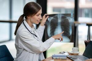 A doctor discusses chest X-ray results with her patient, explaining the health findings in a clear and supportive manner. photo