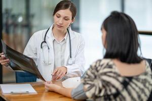 A doctor discusses chest X-ray results with her patient, explaining the health findings in a clear and supportive manner. photo