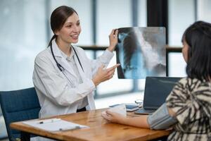 A doctor discusses chest X-ray results with her patient, explaining the health findings in a clear and supportive manner. photo