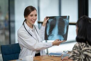 A doctor discusses chest X-ray results with her patient, explaining the health findings in a clear and supportive manner. photo